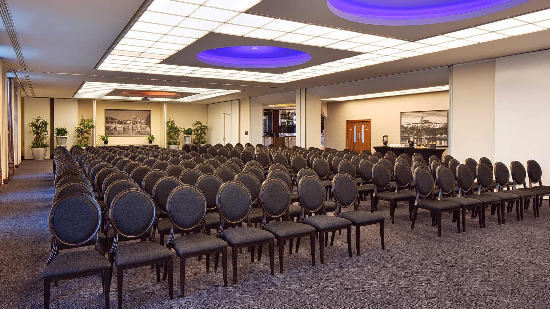 Large cork conference room with seats arranged theatre style